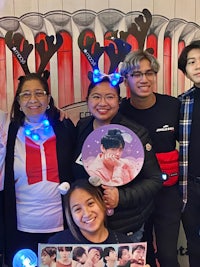 a group of people posing for a photo in a christmas themed room